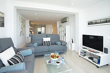 A living room with a couch and a flat screen tv