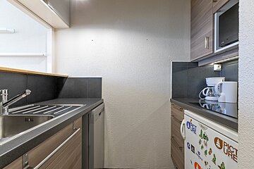 A kitchen with a fridge that says picture on it