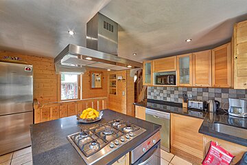 A kitchen with stainless steel appliances and wooden cabinets