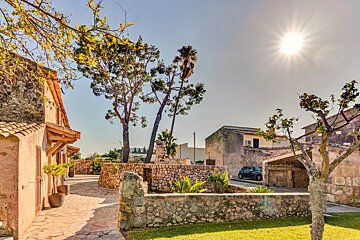 A car is parked in front of a stone wall