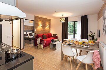 A living room with a dining table and chairs and a couch