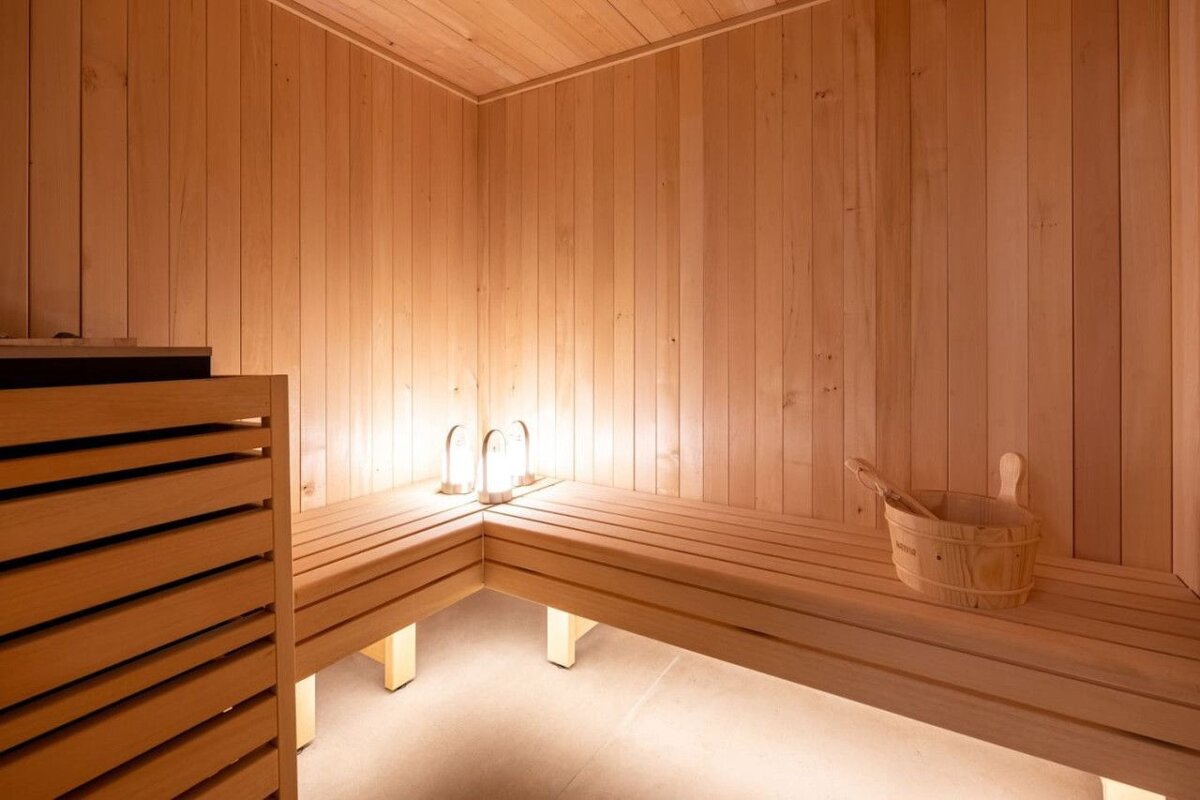 A wooden sauna with a bucket on the bench