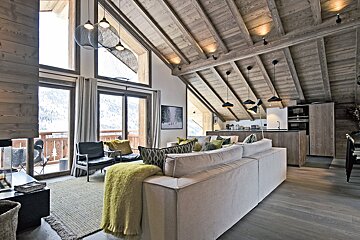 A living room with a white couch and a yellow blanket