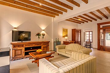 A living room with a couch and a flat screen tv