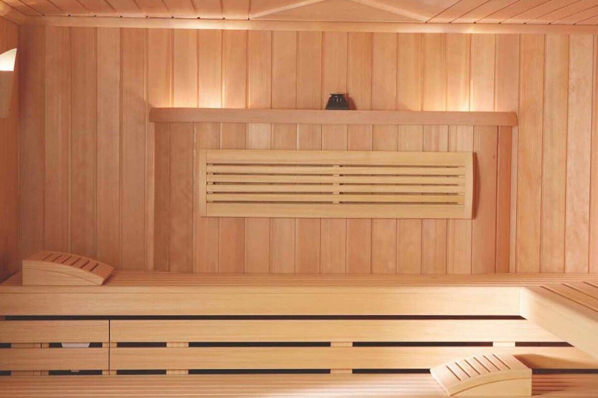 A wooden sauna with a vase on the shelf