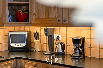 A kitchen with appliances and a sign that says vjp
