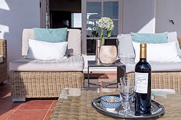 A bottle of teresa wine sits on a tray on a table