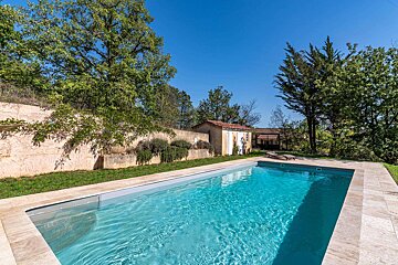 A large swimming pool with a shed in the background