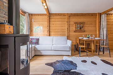 A living room with a white couch and a cow print rug