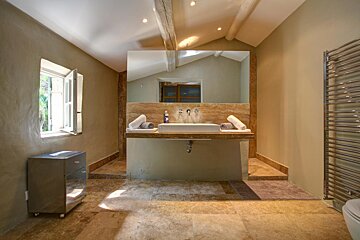 A bathroom with two sinks and a large mirror
