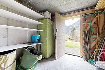 A green closet with a blue bucket on top of it