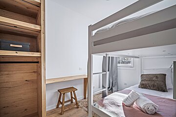 A bunk bed with a ladder leading up to it