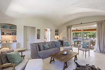 A living room with a couch and chairs and a table