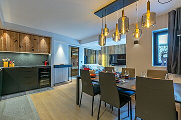 A kitchen and dining area with a table and chairs