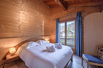 A bathroom with a bathtub and a window