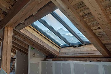 A skylight with a view of a mountain in the background