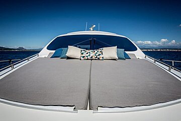 The front of a boat with a bed and pillows on it