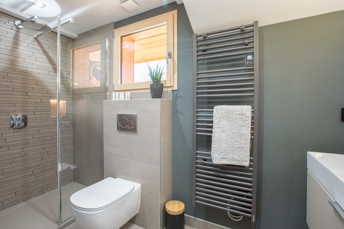 A bathroom with a toilet and a towel rack