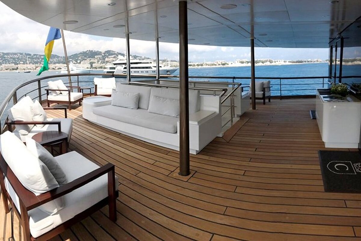 A large yacht with a couch and chairs on the deck