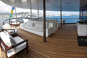 A large yacht with a couch and chairs on the deck