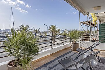 A balcony with a view of a marina and boats