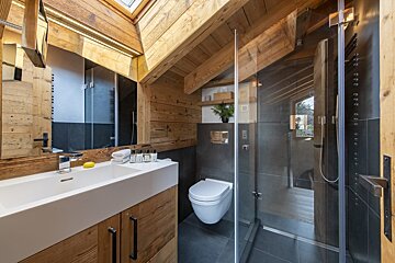 A bathroom with a toilet a sink and a mirror