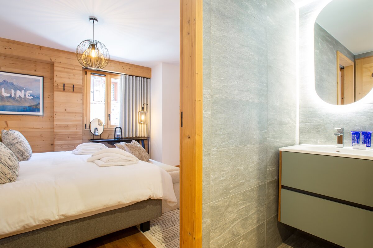 A bedroom with a picture on the wall that says line