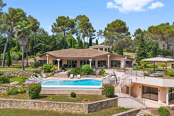 A large house with a large swimming pool in front of it