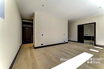 An empty room with a knight frank logo in the corner