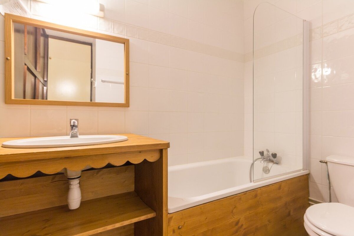 A bathroom with a sink toilet and bathtub