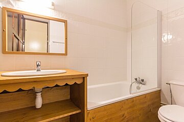 A bathroom with a sink toilet and bathtub
