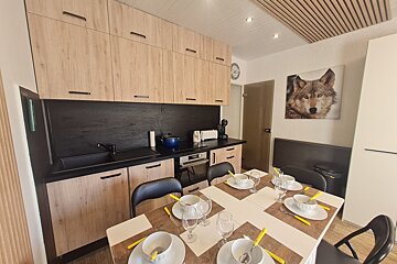 A kitchen with a picture of a wolf on the wall