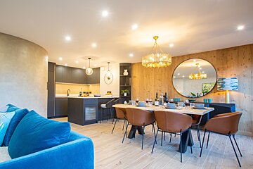 A living room with a dining table and chairs