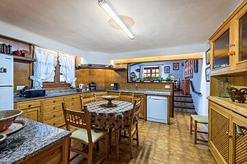 A kitchen with a table and chairs and a dishwasher