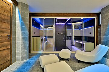 A room with chairs and ottomans and a shower