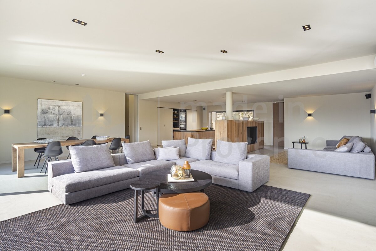 A living room with a couch and a table with the letter b on the ceiling