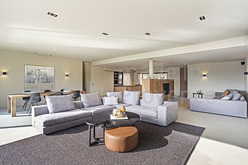 A living room with a couch and a table with the letter b on the ceiling