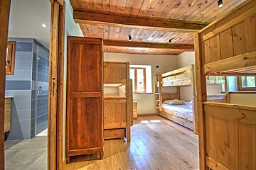 A bedroom with bunk beds and a dresser