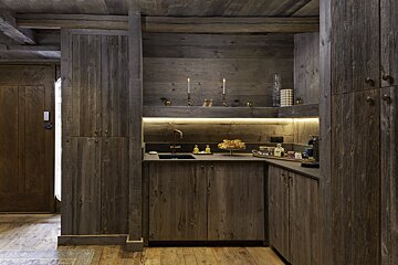 A kitchen with wooden cabinets and a sink