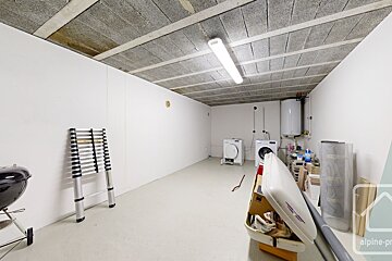 A laundry room with a ladder and a washing machine