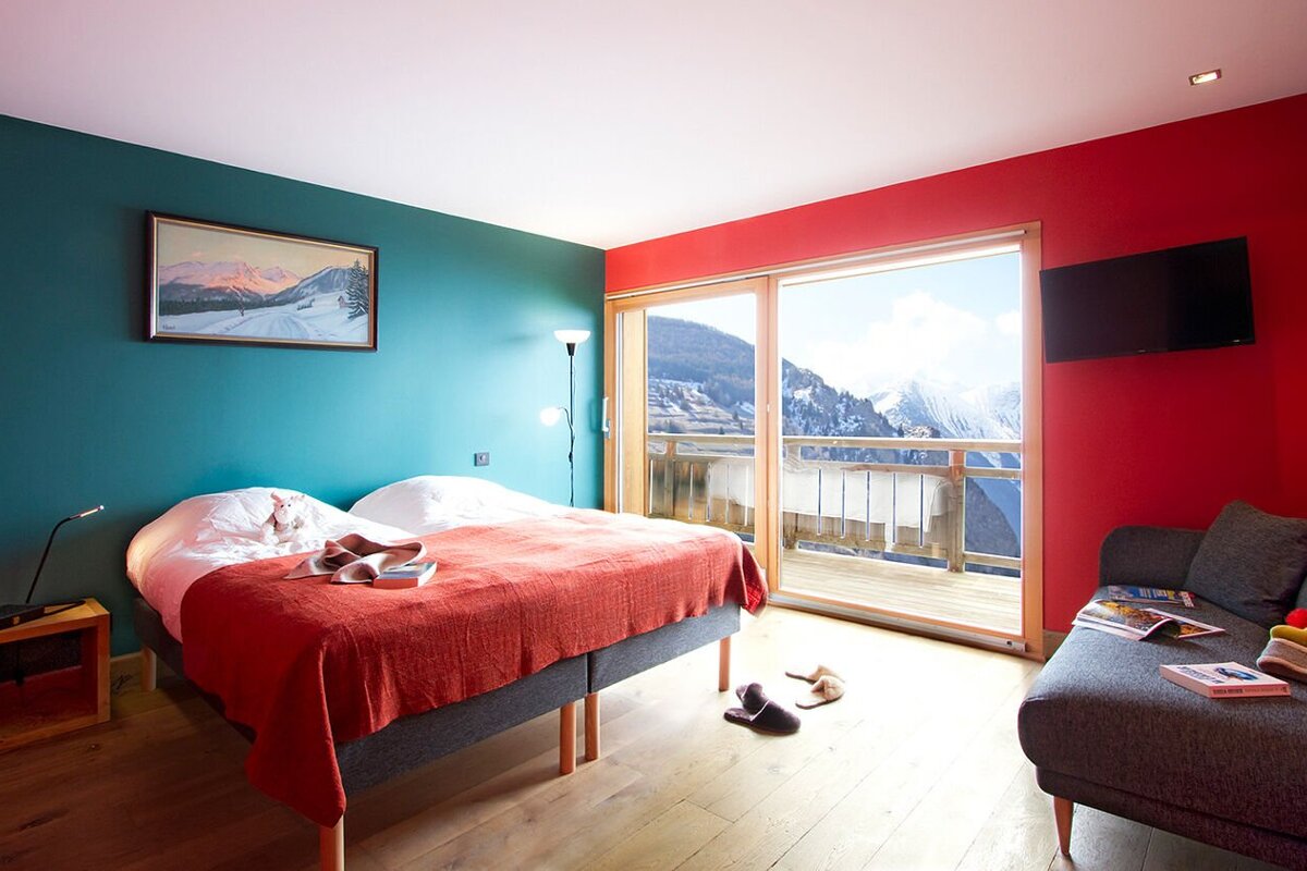 A bedroom with a large bed and a couch