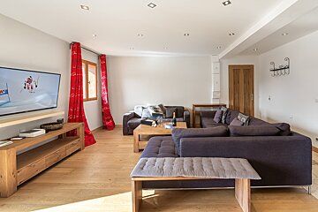 A living room with a couch and a flat screen tv
