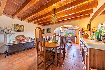 A dining room with a wooden table and chairs