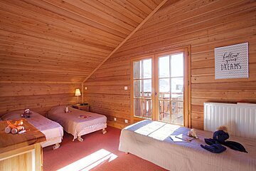 A bedroom with two beds and a sign that says follow your dreams