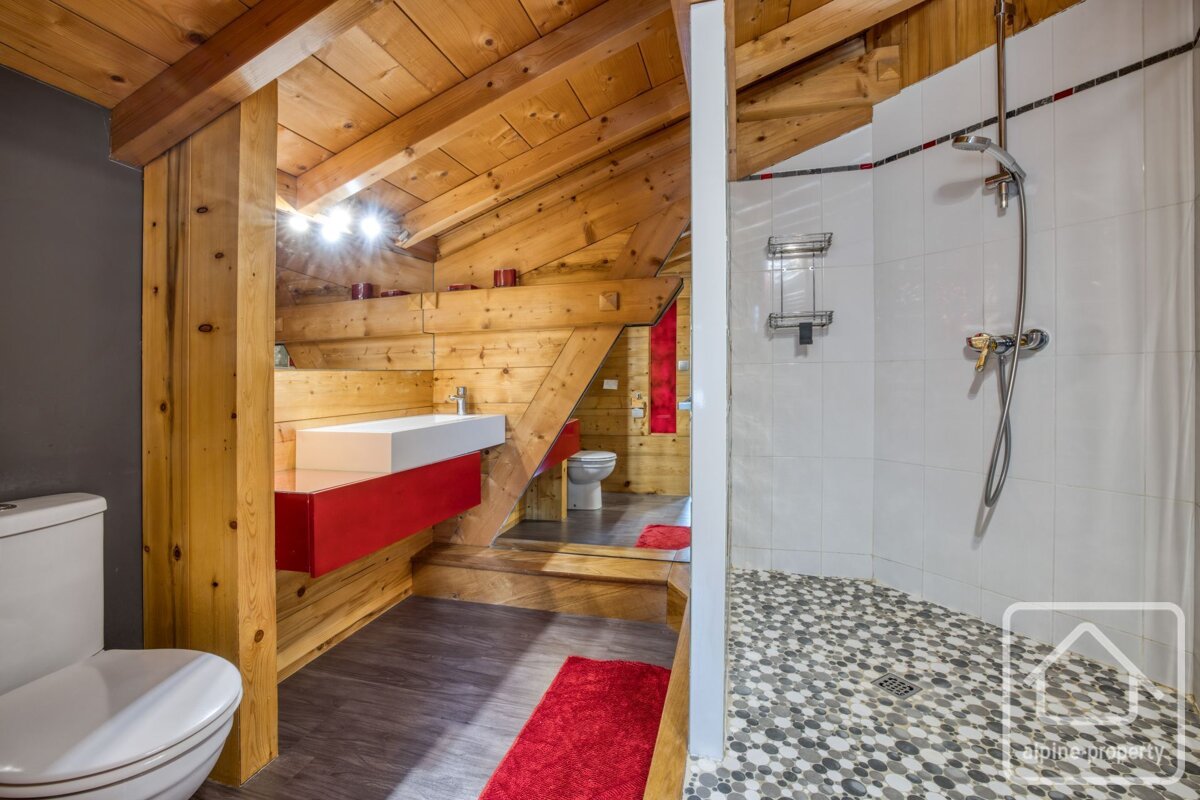 A bathroom with a walk in shower and a toilet