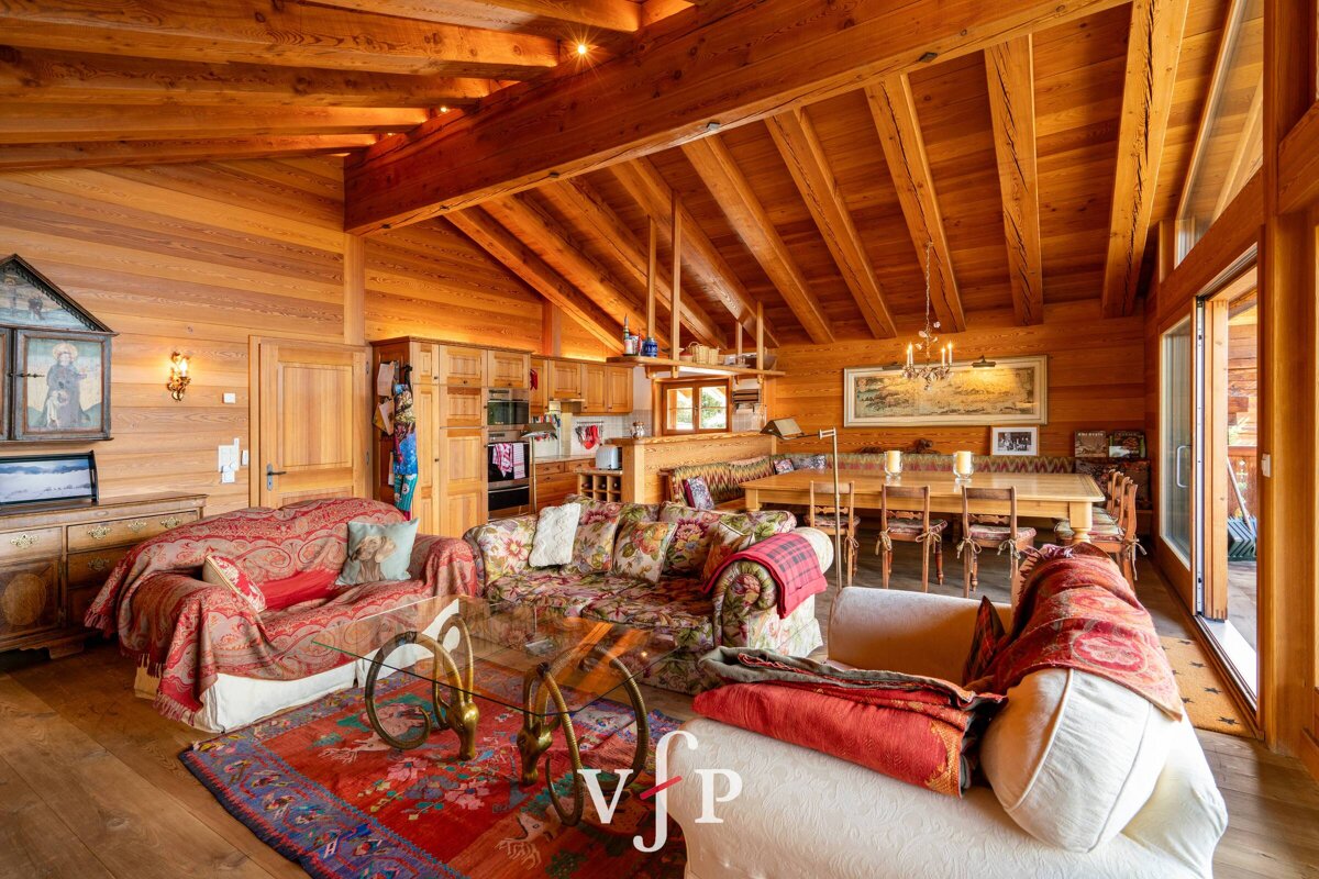 A living room with a couch that has the letter v on it