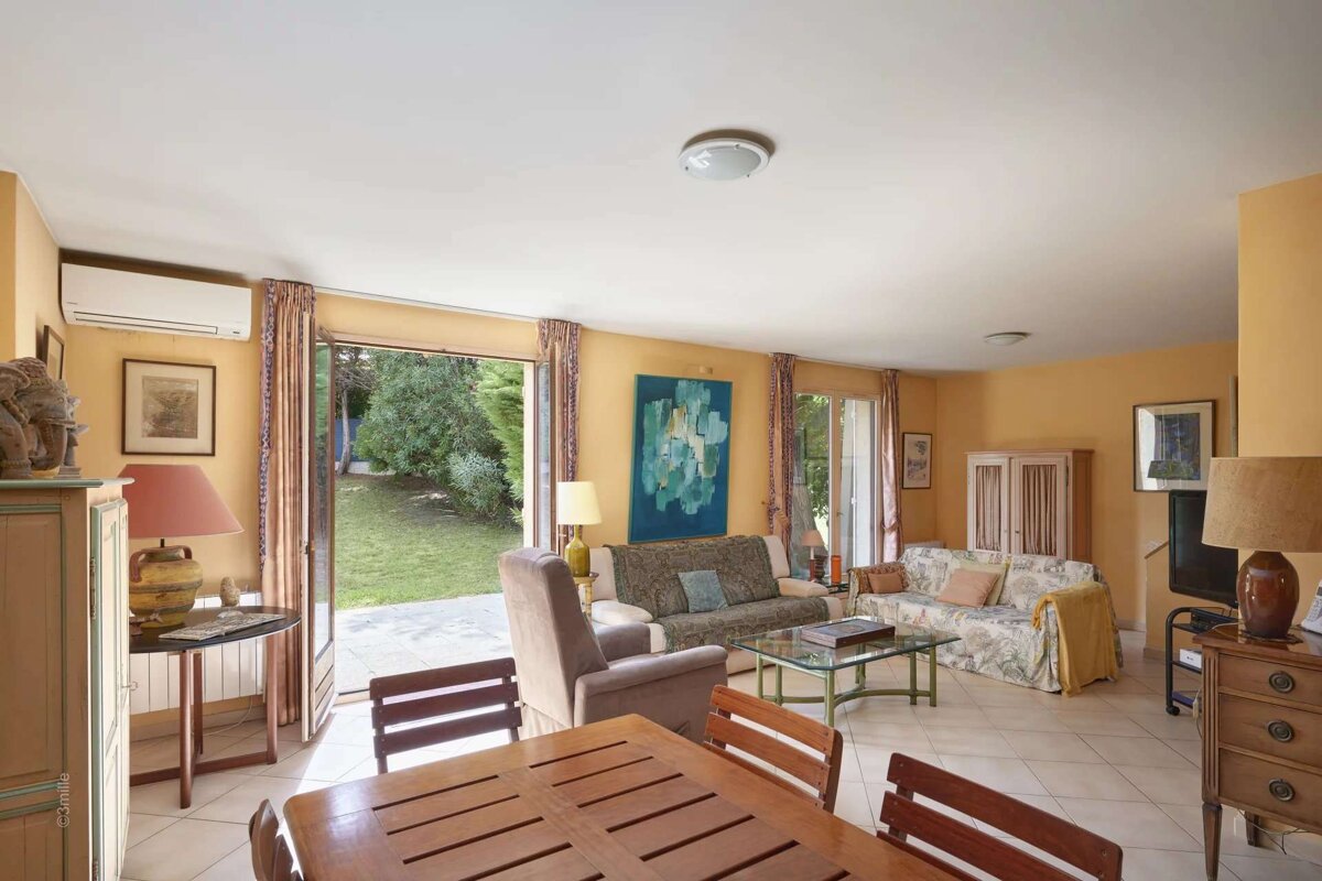 A living room with a couch and chairs and a table