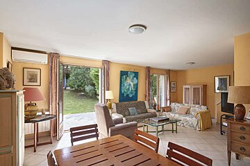 A living room with a couch and chairs and a table