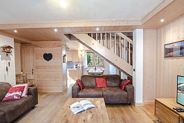 A living room with a couch and a book on the table