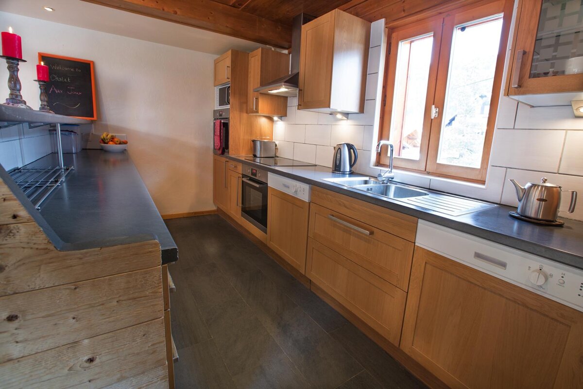 A kitchen with a sign on the wall that says 